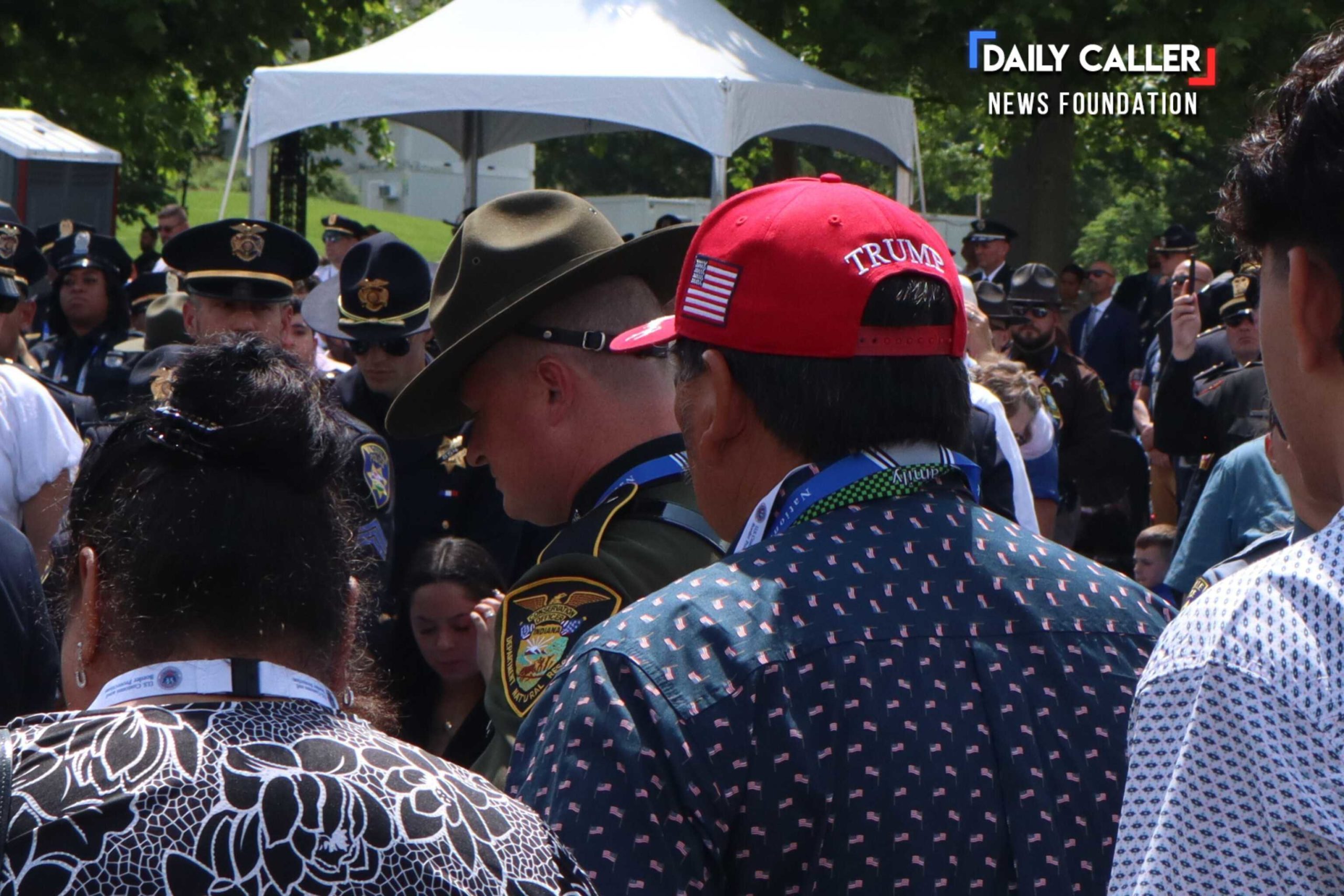 A guest wearing a "Make America Great Again" cap is welcomed with other families and law enforcement at the National Peace Officers' Memorial Service on May 15, 2025 in Washington, D.C.