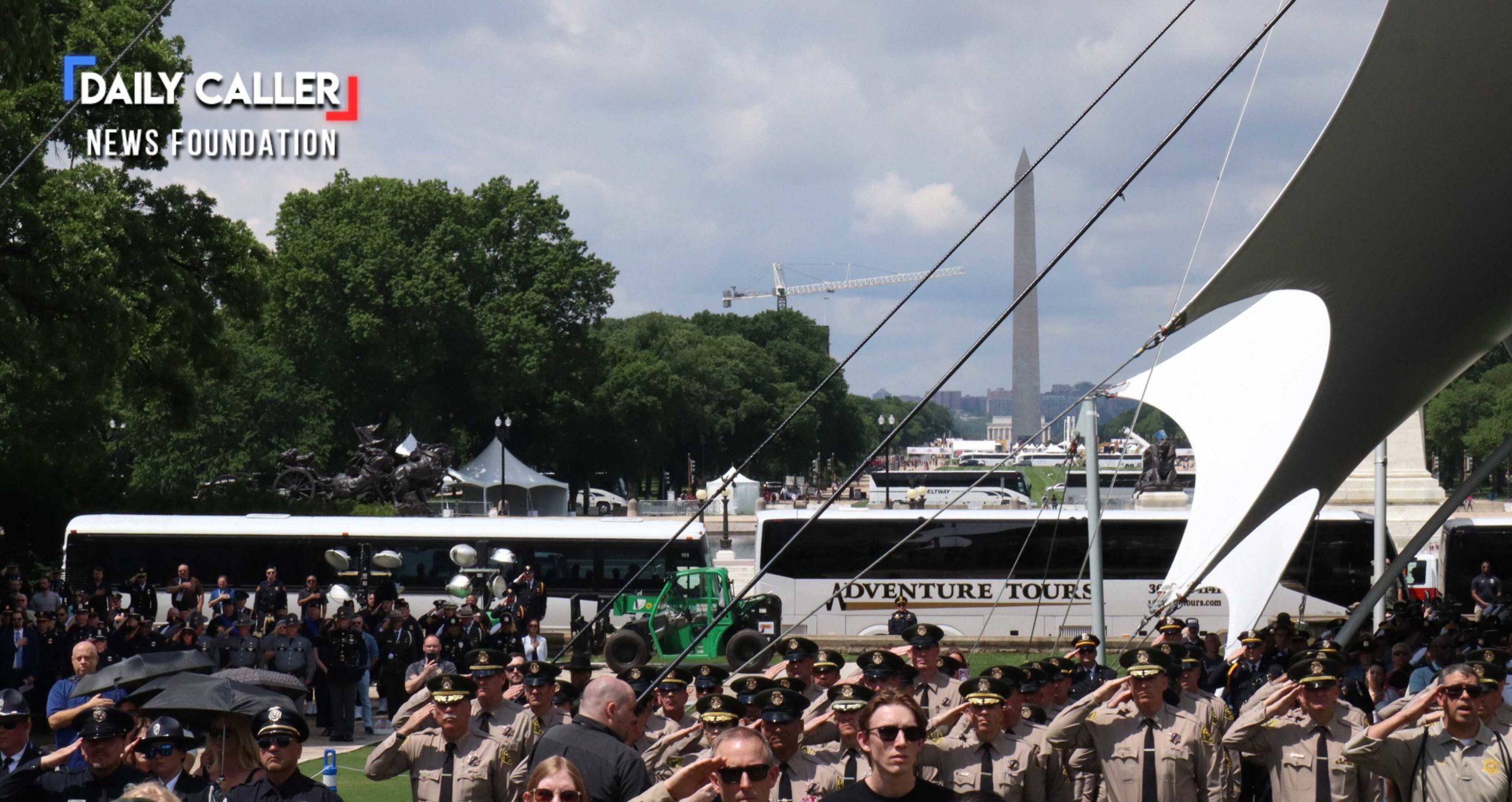 Law enforcement officers salute during a singing of the national anthem at the National Peace Officers' Memorial Service on May 15, 2025 in Washington, D.C.